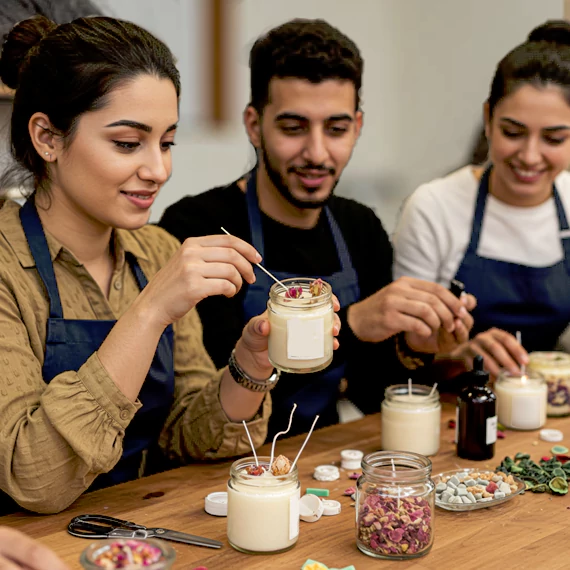 Corporate professionals participating in a candle-making workshop in Dubai, crafting personalized candles as part of a creative corporate learning experience